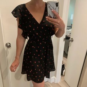 Black dress, with a red strawberry pattern.